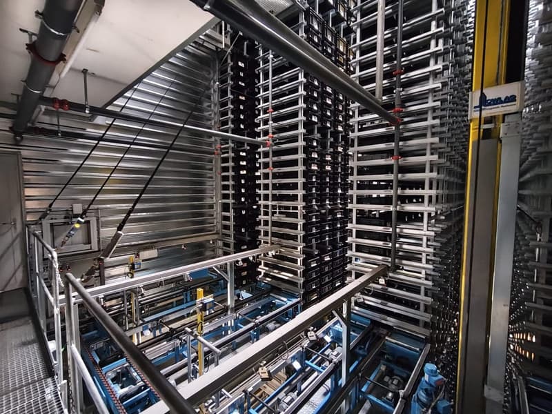 Industrial facility with metal racks, conveyor systems, and machinery