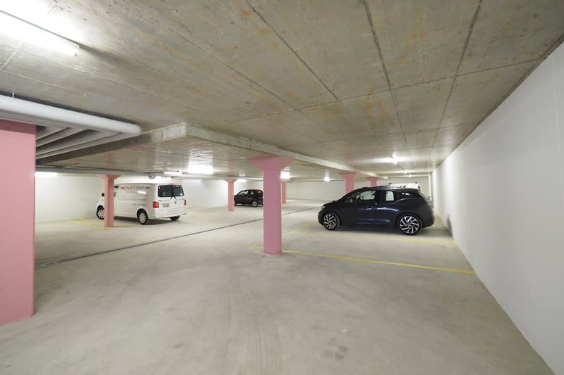 A few cars parked in an underground parking space