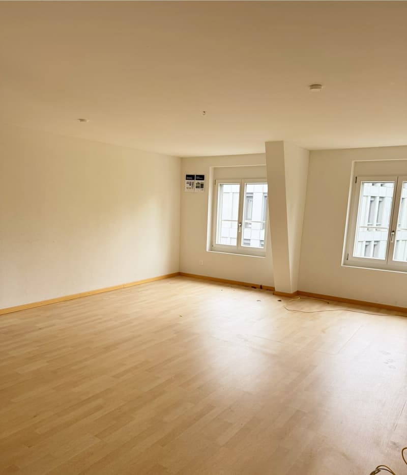wooden floor, white walls, large windows, two-story view
