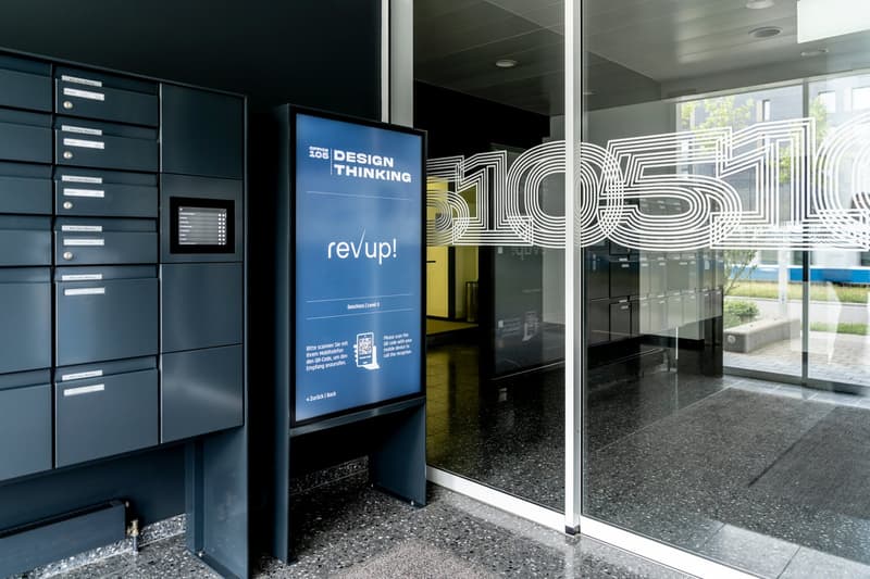 Entrance of office building with security lockers and automated mail delivery system