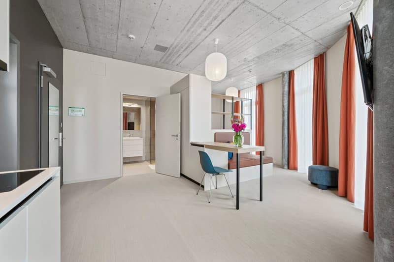 open floor plan, modern kitchen, living room, dining table, blue chair, bench, mirror, tv