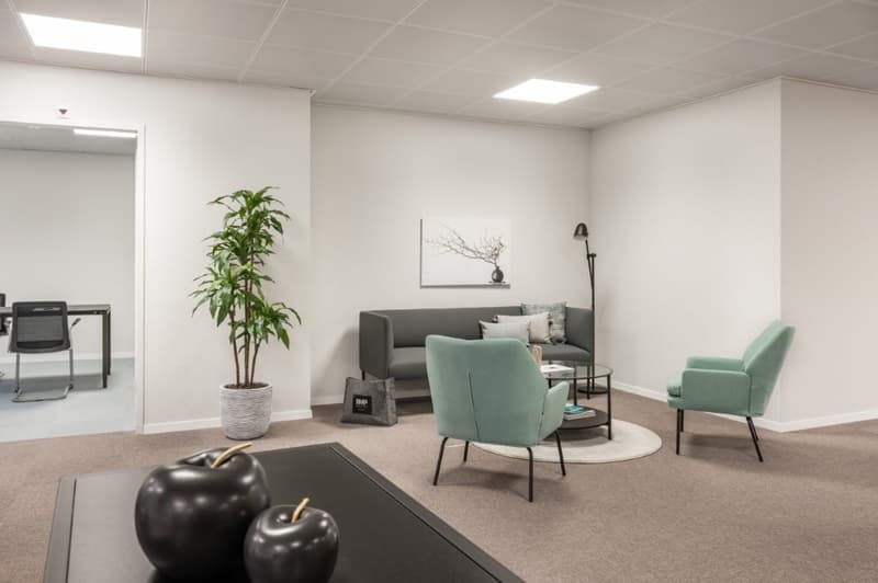 contemporary living room, gray sofa, glass coffee table, green armchairs, floor lamp, potted plant, artwork