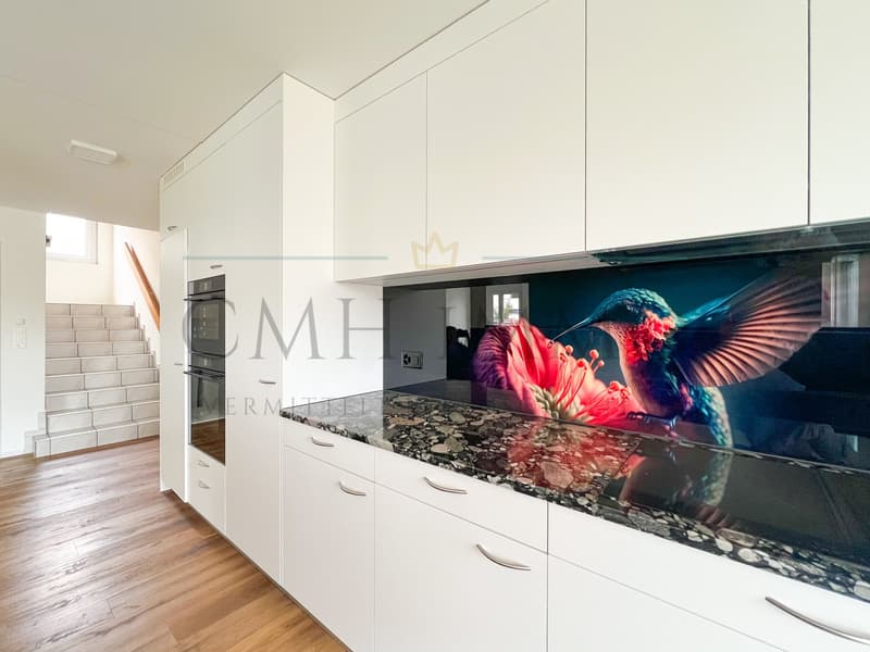 modern kitchen with white cabinets, wooden floor, granite countertop, built-in oven, and a decorative backsplash