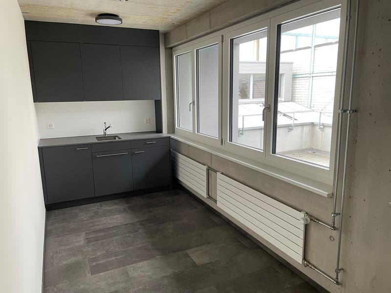 kitchen with cabinets, sink, window, radiators, tiled floor