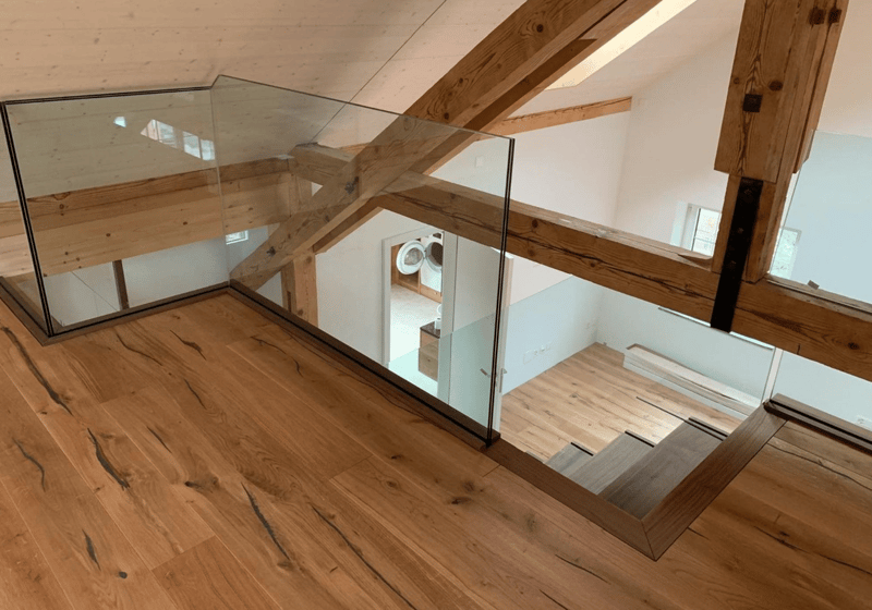 Atrium room, wood floor, glass railing, beams, washer machine