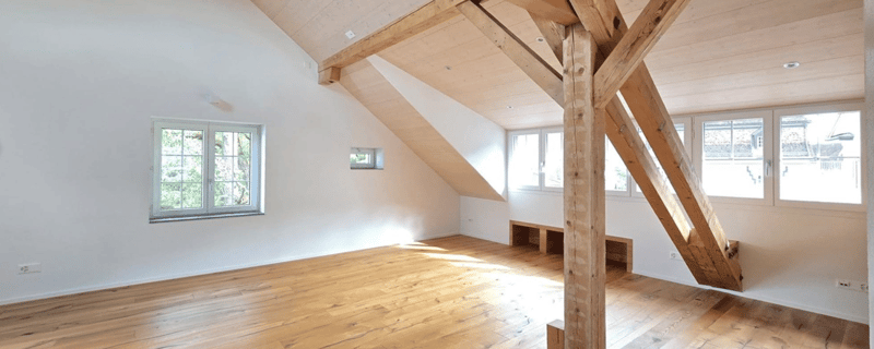 empty room, hardwood floor, wooden beams, windows, natural light