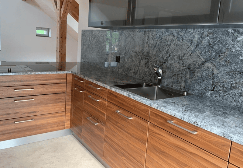 modern kitchen, wooden cabinets, granite countertop, stainless steel sink, faucet, electrical outlet