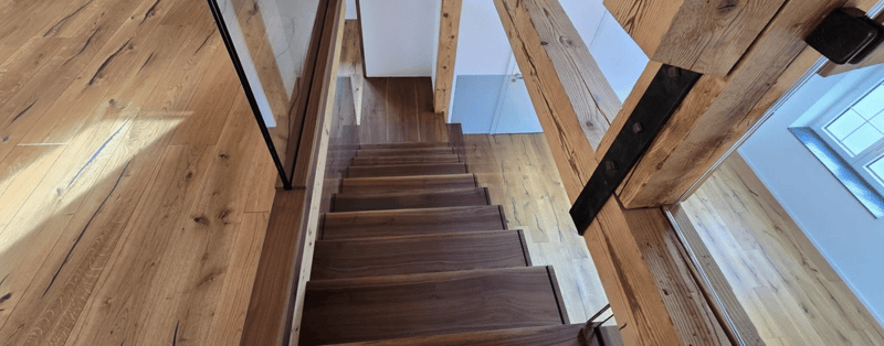 wooden floor, dark wood steps, glass and wood railing, window