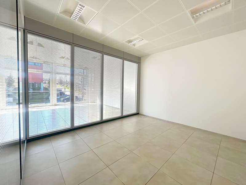 empty room, large windows, tiled floor, white walls, outside view of pool and cars