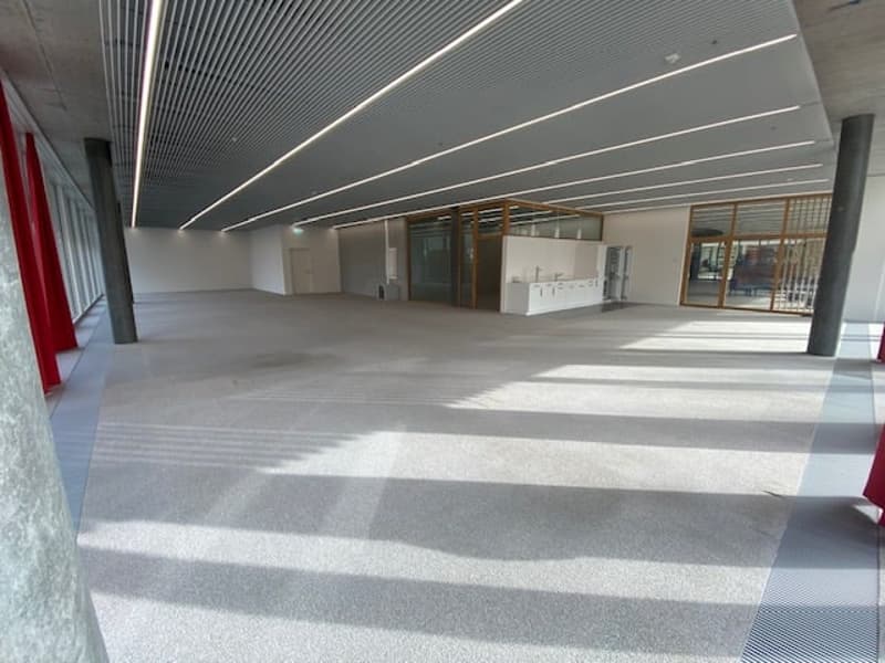 Empty room, modern ceiling design with recessed lighting, glass walls, white flooring, grey walls