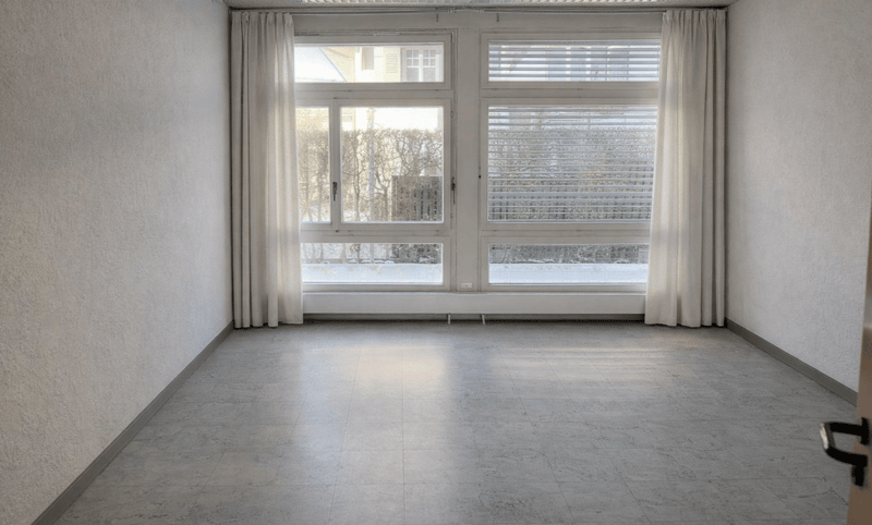 tiled floor, white walls, double windows with white curtains, single open door