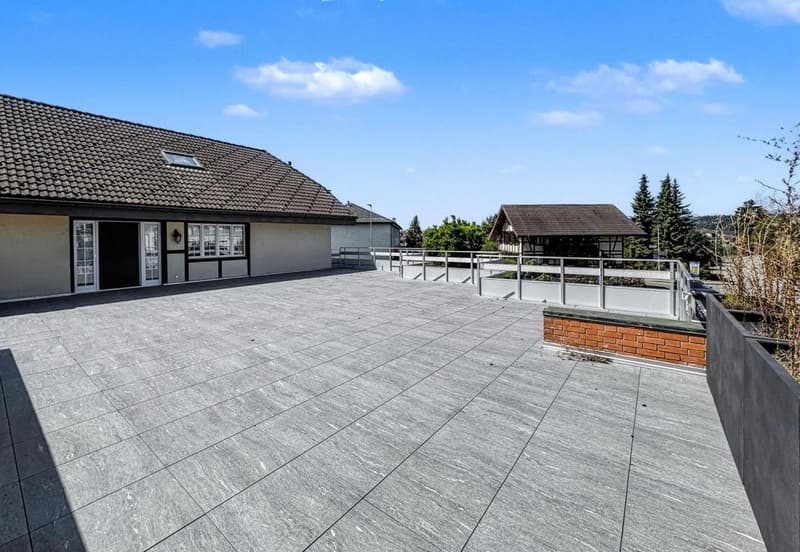 Concrete roof terrace, tiled floors, fence, metal railings, clear sky