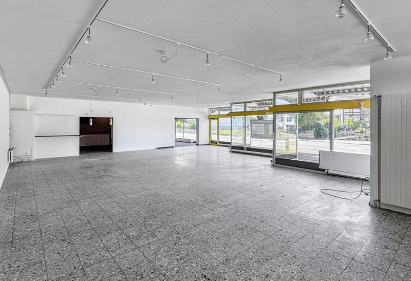 Empty room, tile floor, glass doors, two entrances, lights on ceiling
