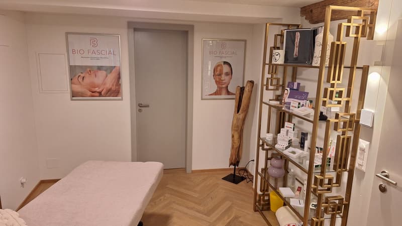 wooden floor, treatment bed, decorative shelves, wall decor, door