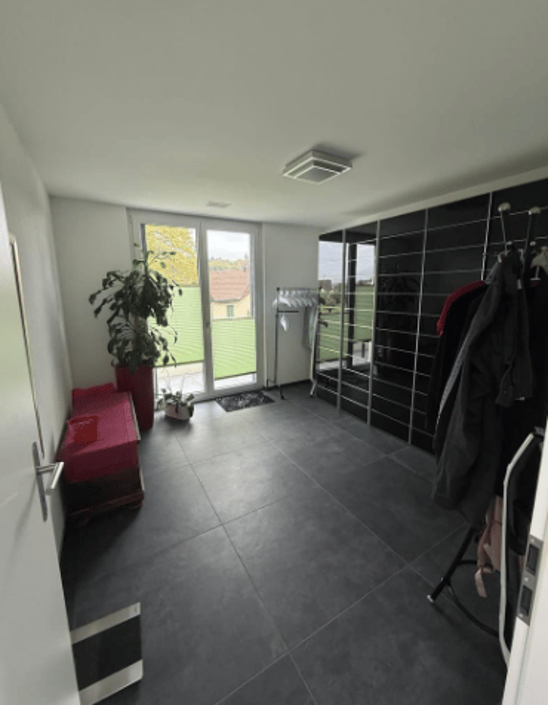 tiled floor, sliding glass door, potted plant, clothes rack