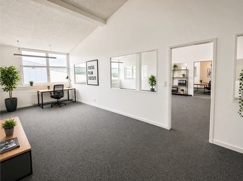 Empty office with desks, chairs, plants, and a motivational sign on the wall.