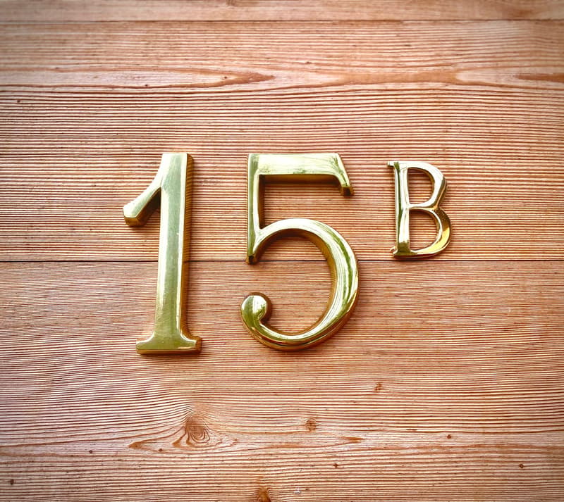 gold colored number 15B on wooden background