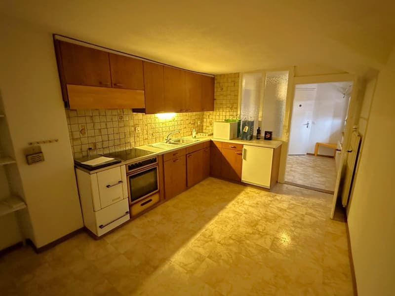 kitchen with wooden cabinets, tiled backsplash, white appliances, sink, stove, oven, countertop, open door