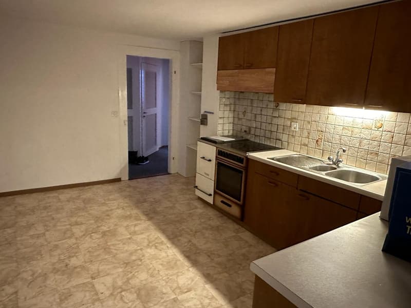 empty kitchen with tiled floor, wooden cabinets, sink, oven, dishwasher, washing machine