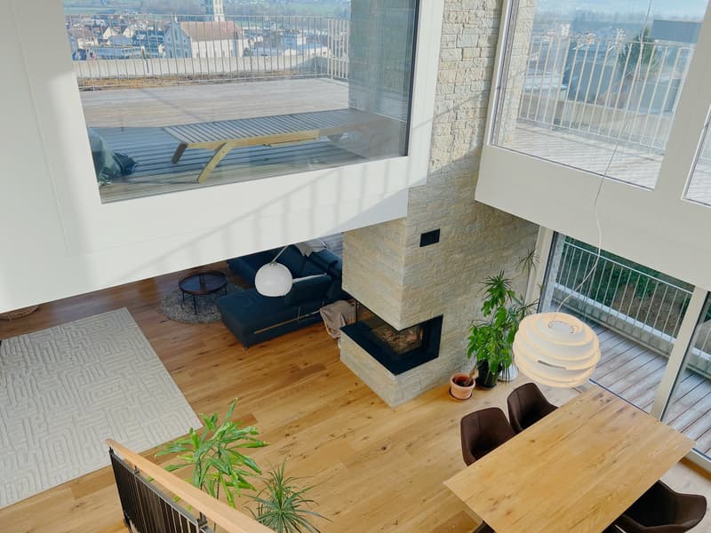 Open floor plan, living room with fireplace, dining area, balcony, hardwood floors, large windows, modern decor
