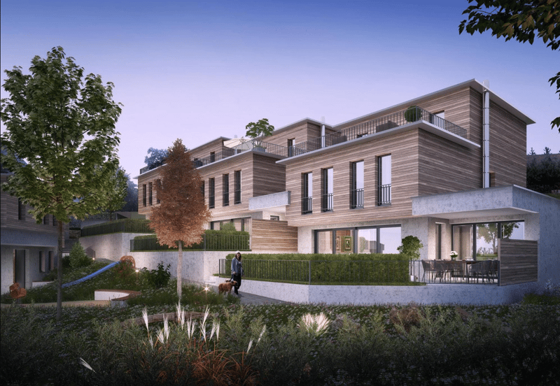 Modern multi-story house with wooden facade, large windows, and a balcony. The house is surrounded by a garden with a slide and a bench.