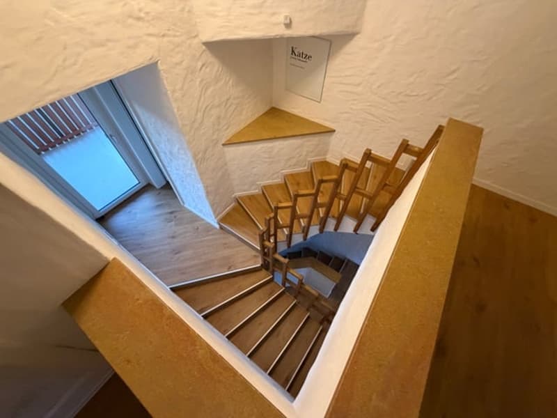 staircase from ground floor, wooden handrail and steps, raised first floor