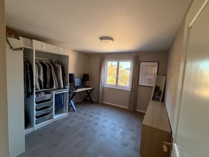 large wardrobe, desk with computer monitor, cabinet, window, curtain