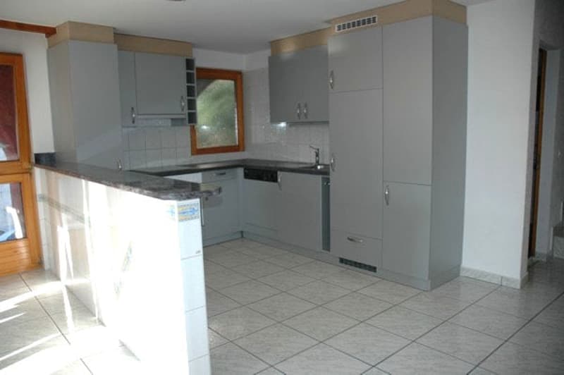 empty kitchen with white tiles, wooden cabinets, sink, dishwasher, window