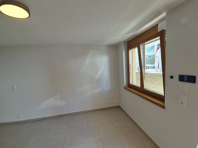 white walls, wooden window frame, tiled floor, ceiling lamp, power outlets, window