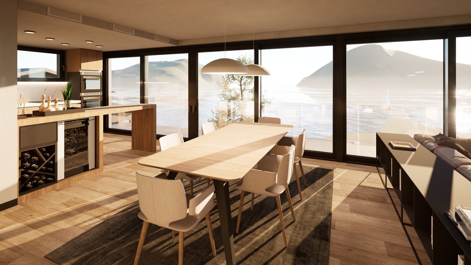 Spacious open-plan living and dining area with large windows offering a scenic view of the lake and mountains. The room features a wooden dining table with chairs, a kitchen area with built-in appliances, and a cozy seating area with a sofa. The overall d