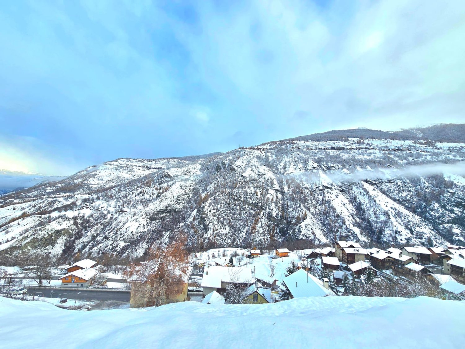 Snowy mountains, several houses, village