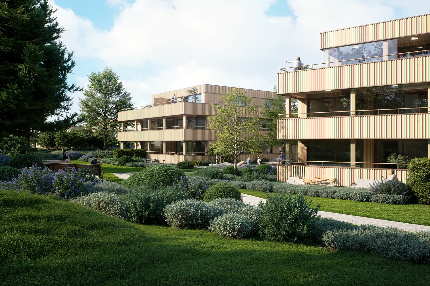 Two-story building with balconies, surrounded by a garden with various plants and trees.