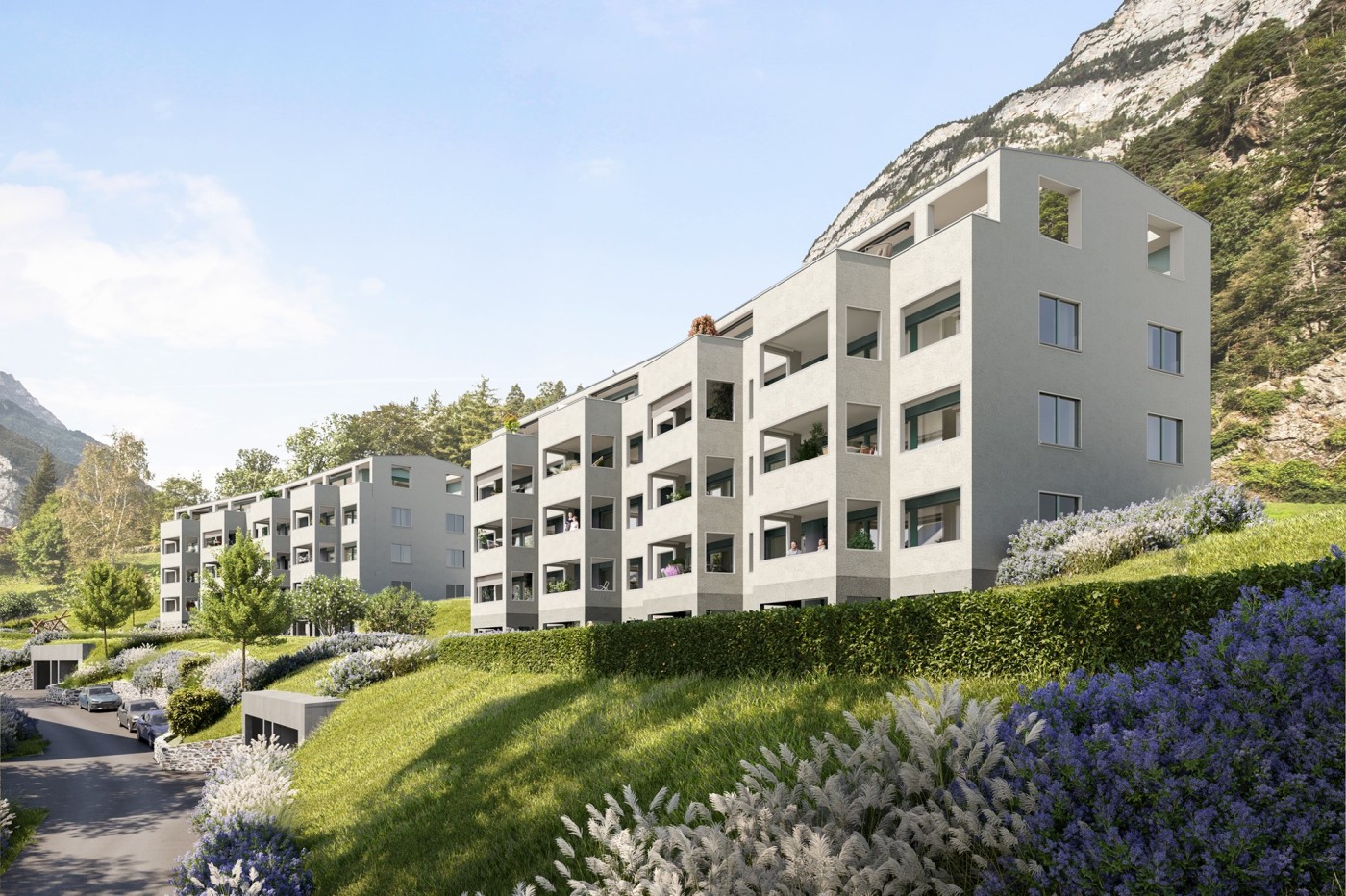 Modern residential complex on slope, balconies, green landscape, mountain view