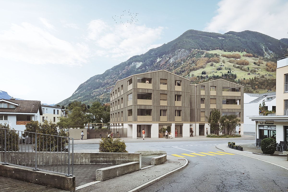 Modern multi-story residential building with several windows and balconies, positioned on an elevated ground floor for mountain view, surrounded by greenery.