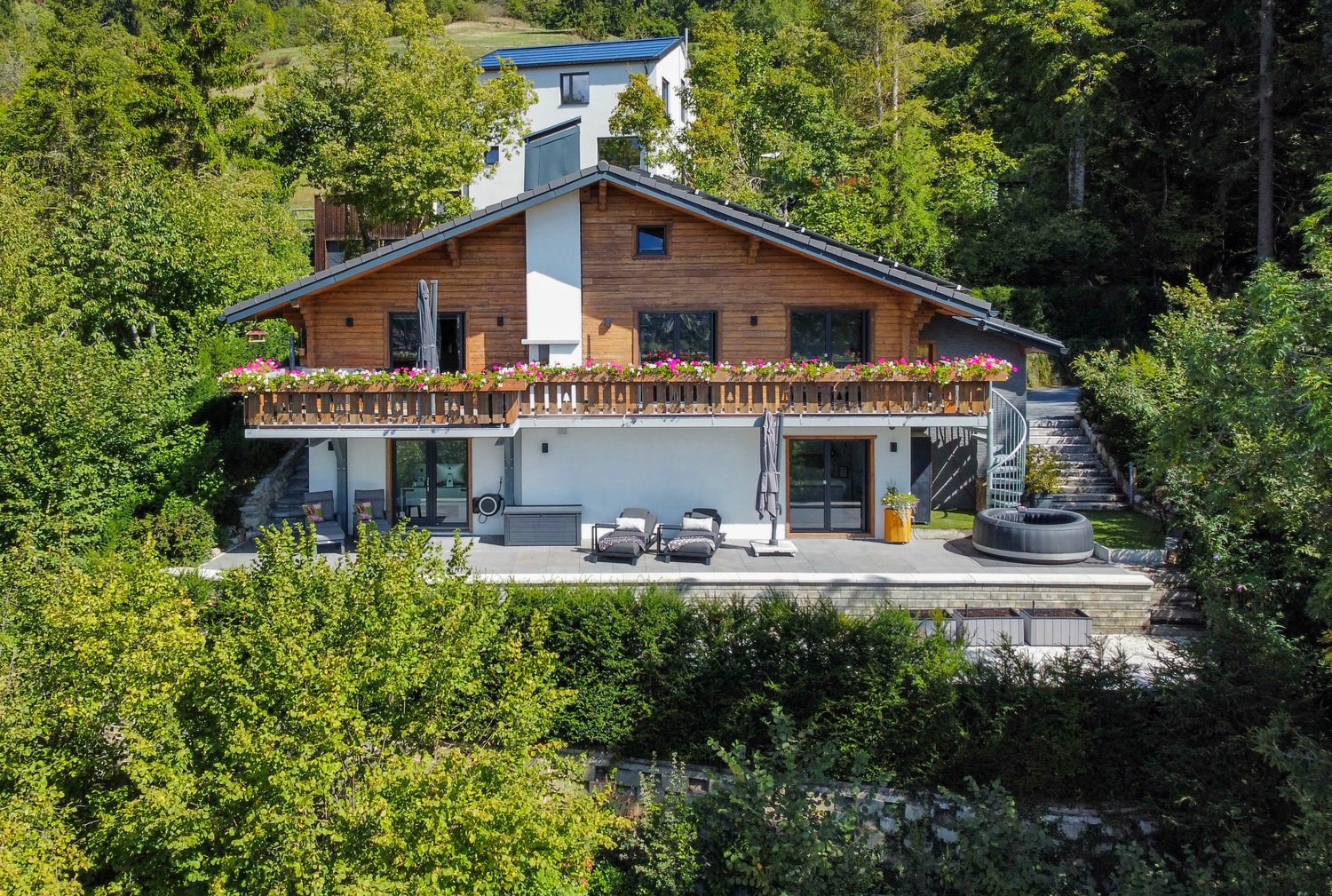 detached house, wooden exterior, balcony with flower boxes, outdoor pool, outdoor seating, garden