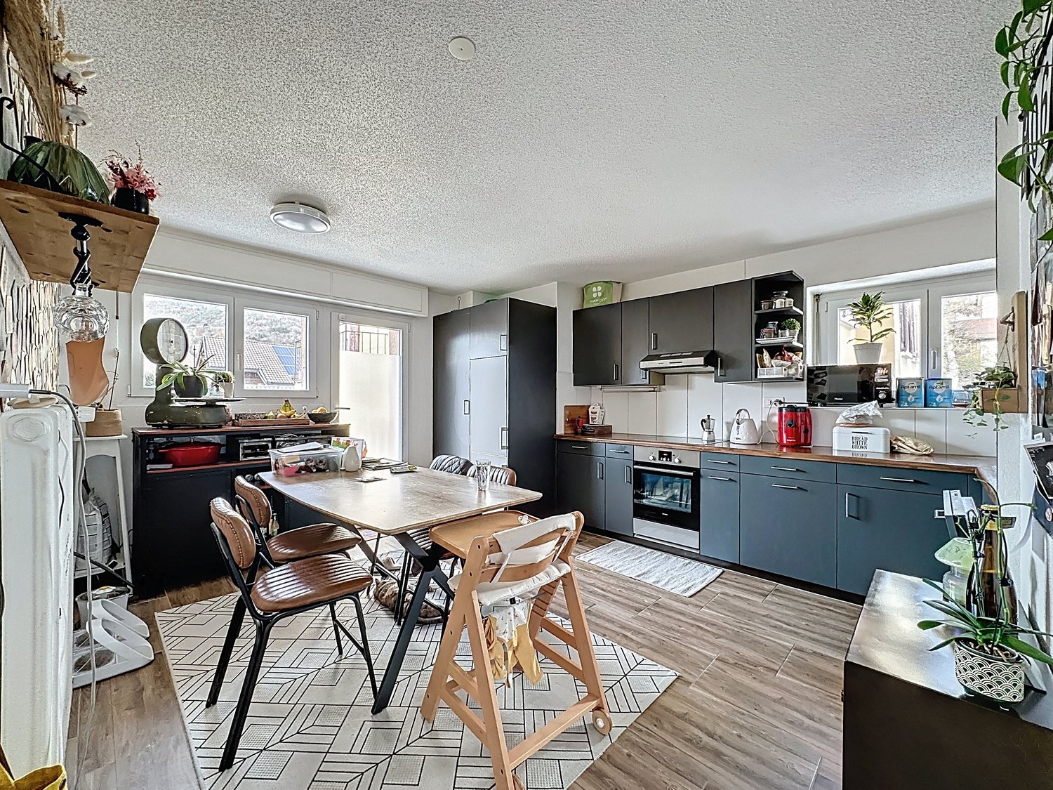 Open-plan kitchen and dining area with modern appliances and wooden floor