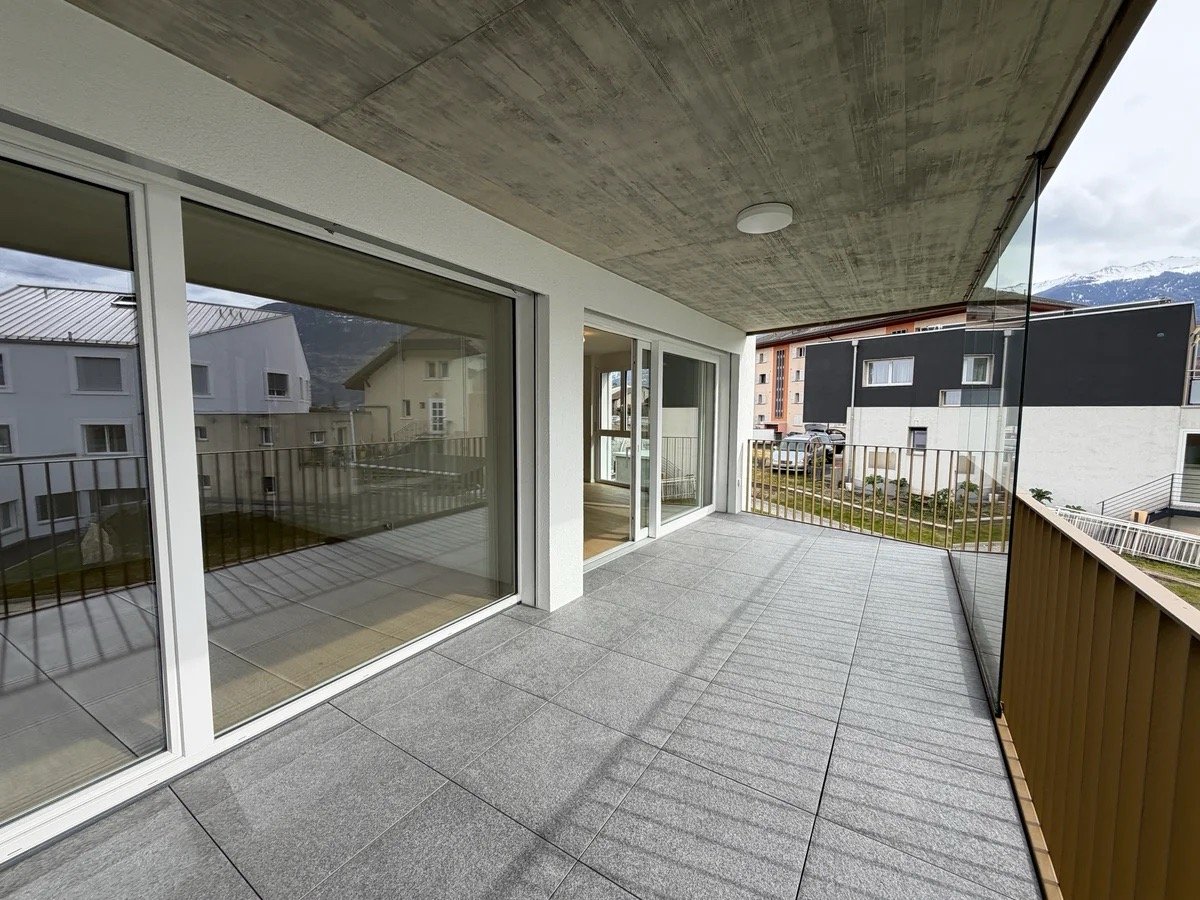 large balcony, glass walls, tiled floor, metal railings, view of mountains