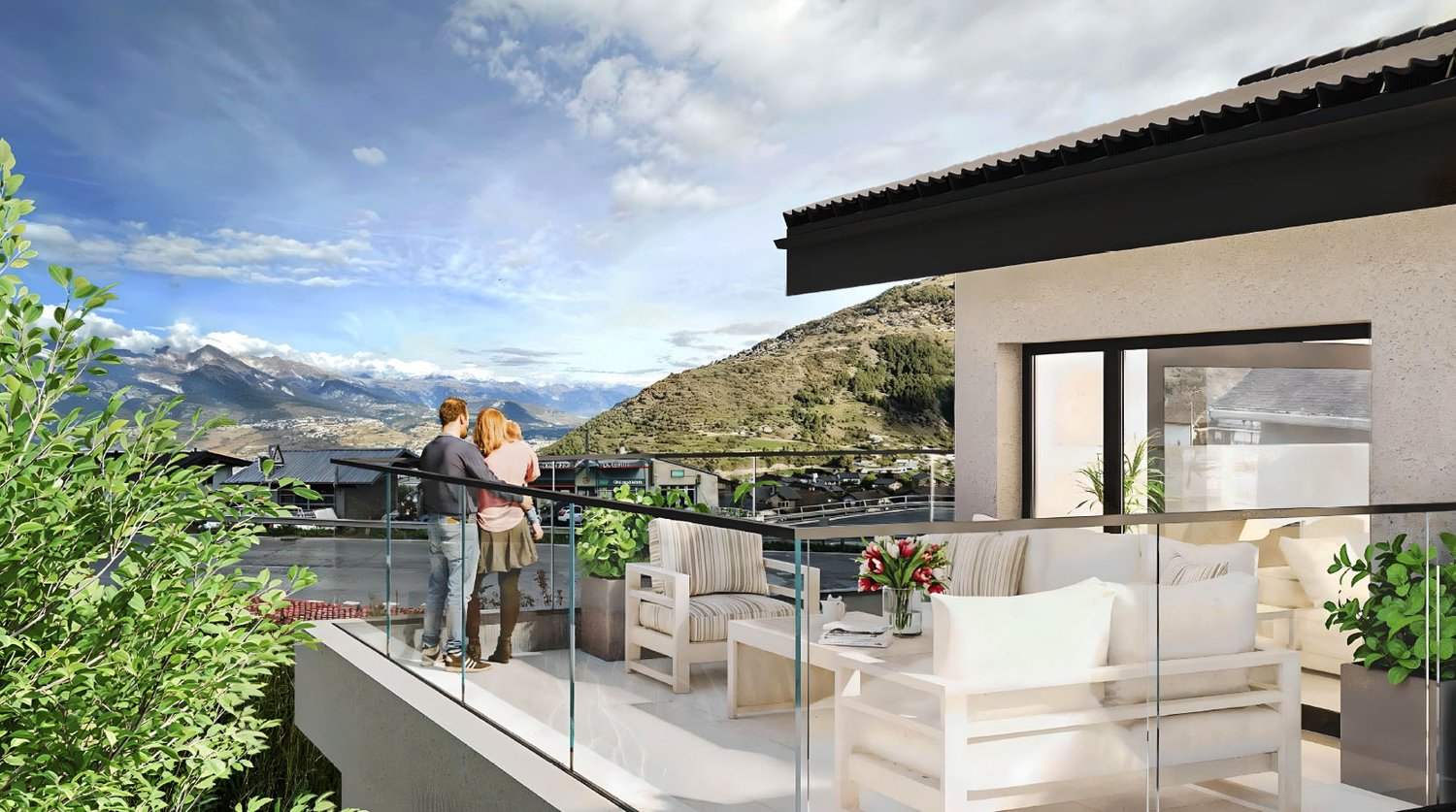 large balcony with plants, two people standing on balcony, white couches, table with flower vase, glass railing, mountain view in the distance