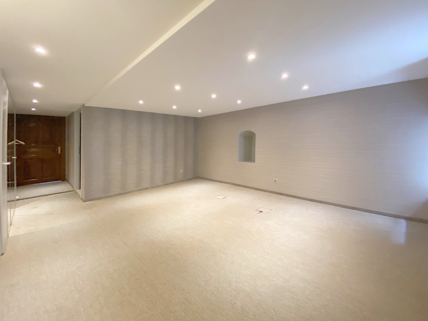 empty room, neutral color walls, carpeted floor, recessed ceiling lights, small window