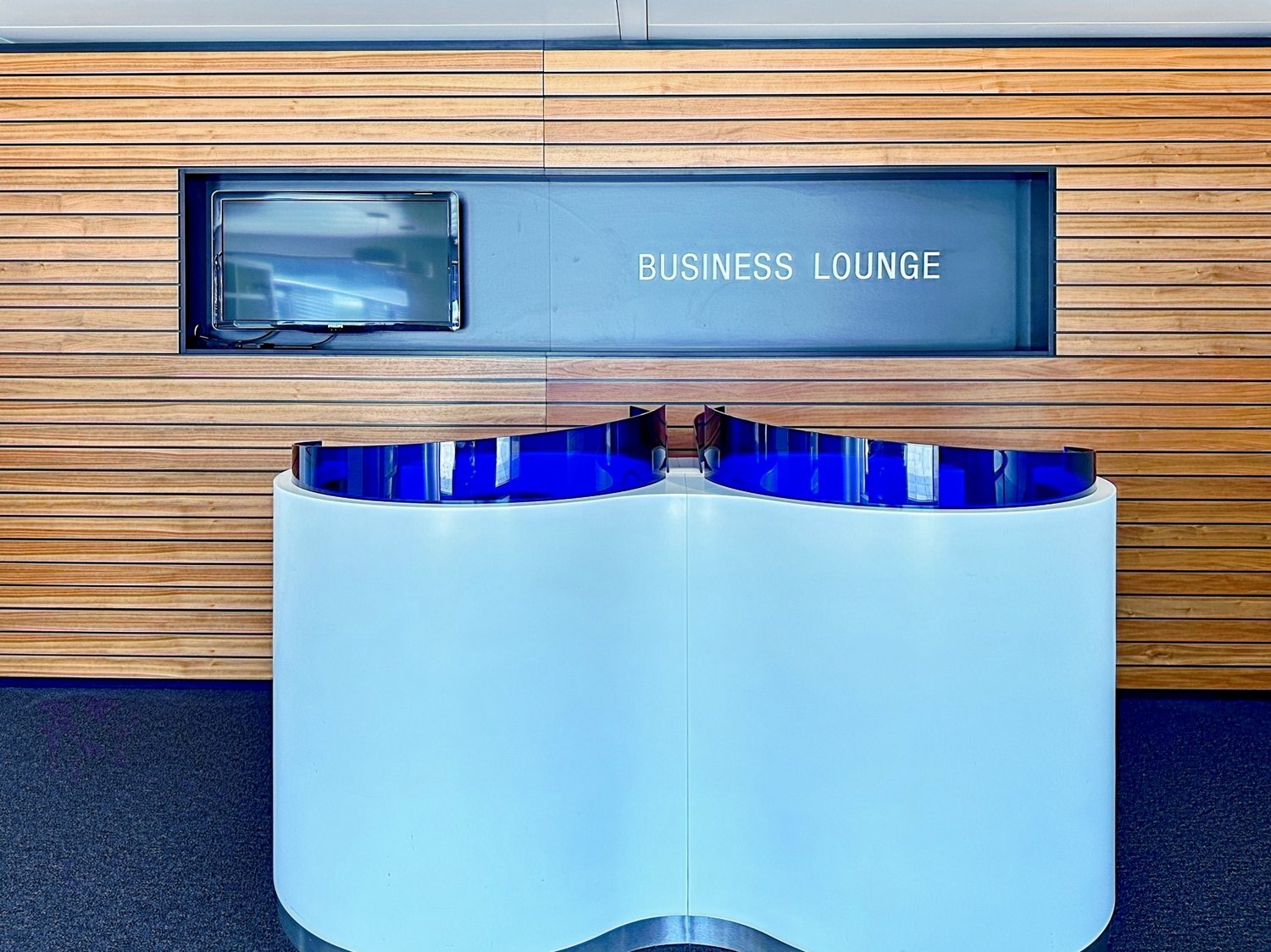 Modern wooden wall, blue front desk, integrated monitor