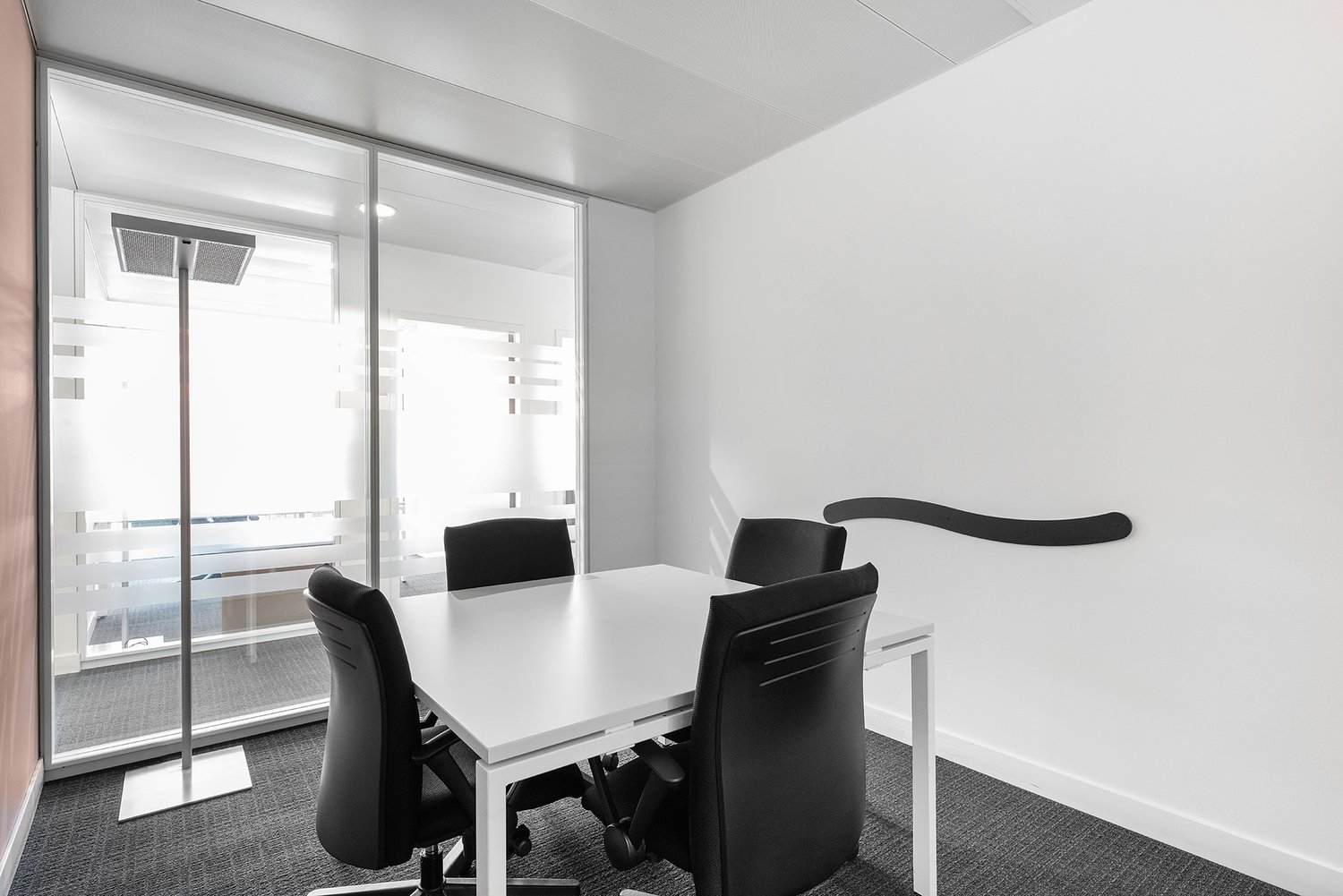 modern office meeting room, white table, black chairs, glass wall, carpeted floor