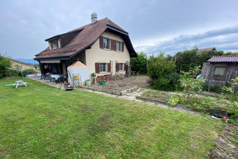 2 story house, brown roof, beige walls, large garden, patio, shed