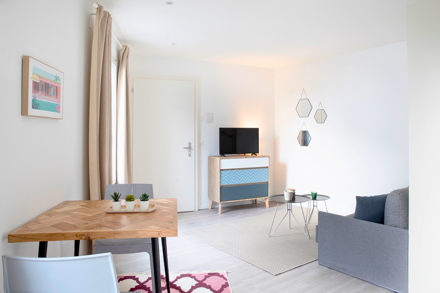 Minimalist design, wooden table, sofa, TV on cabinet, framed art, rug