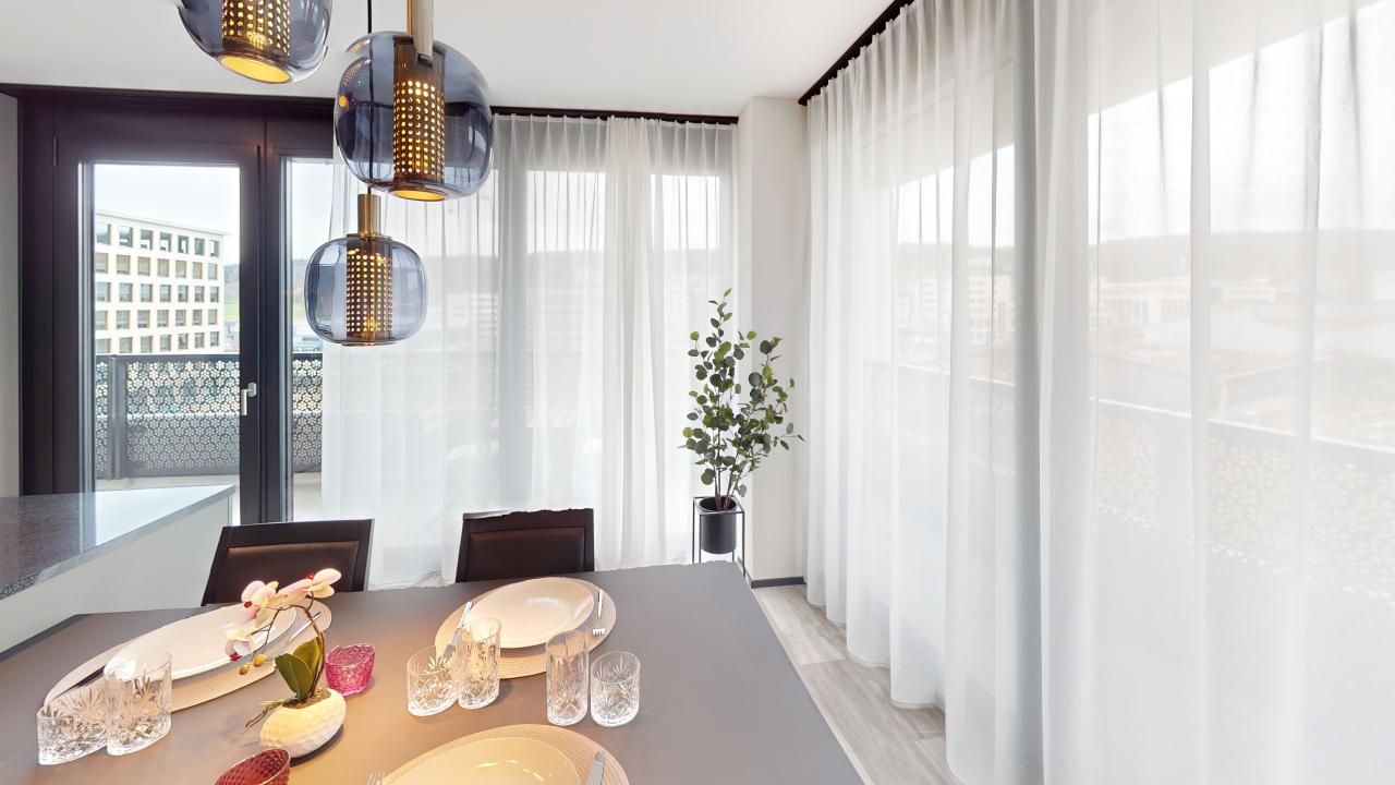 Dining room with a table, chairs, and a balcony with a view of the city