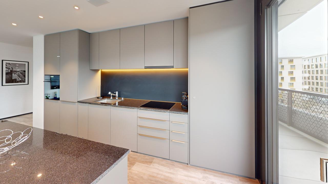 modern kitchen with granite countertop, stainless steel sink, gas stove, white cabinets, balcony