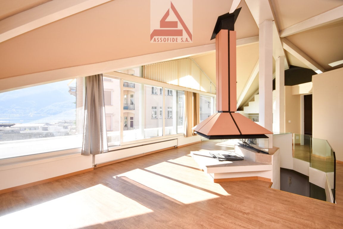 large windows, fireplace, wooden floor, spacious layout, city view