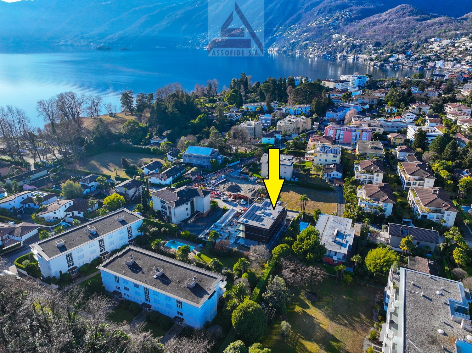 cluster of houses, swimming pool, green surroundings, lakeside view