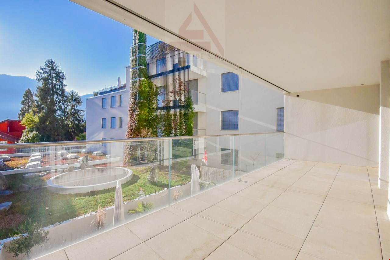 Terrace with glass railings, tiled floor, panoramic views of surrounding mountains and landscape