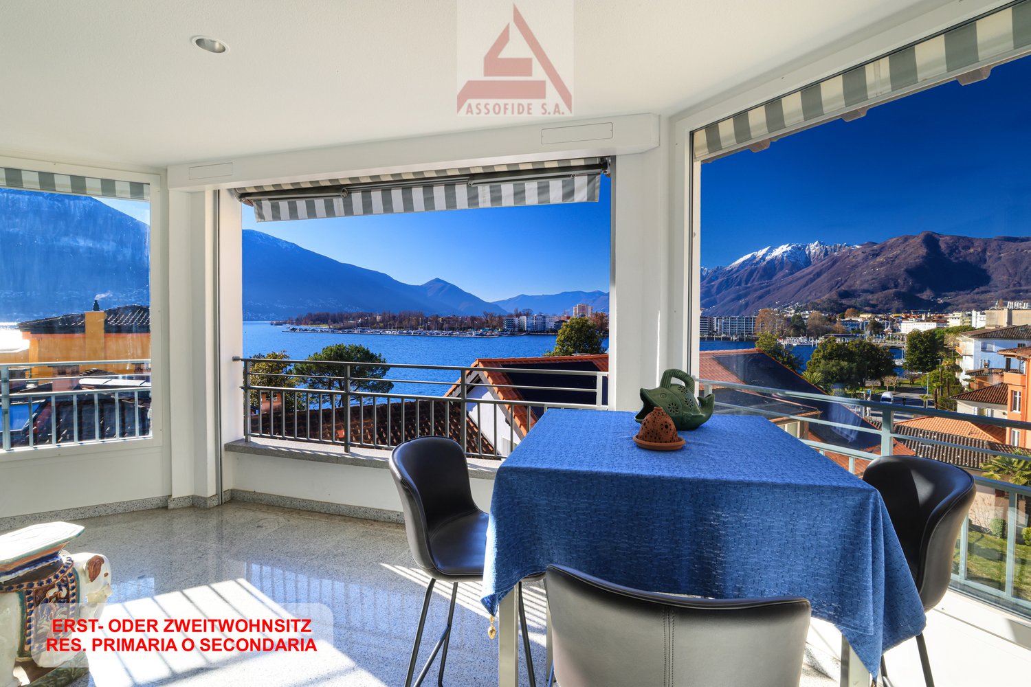 dining room with balcony, table, chairs, view of mountains and lake