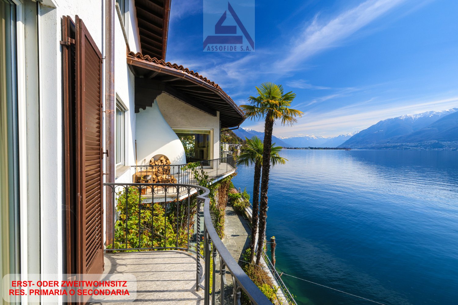 House with balcony, overlooking the lake, mountains in the background, palm trees
